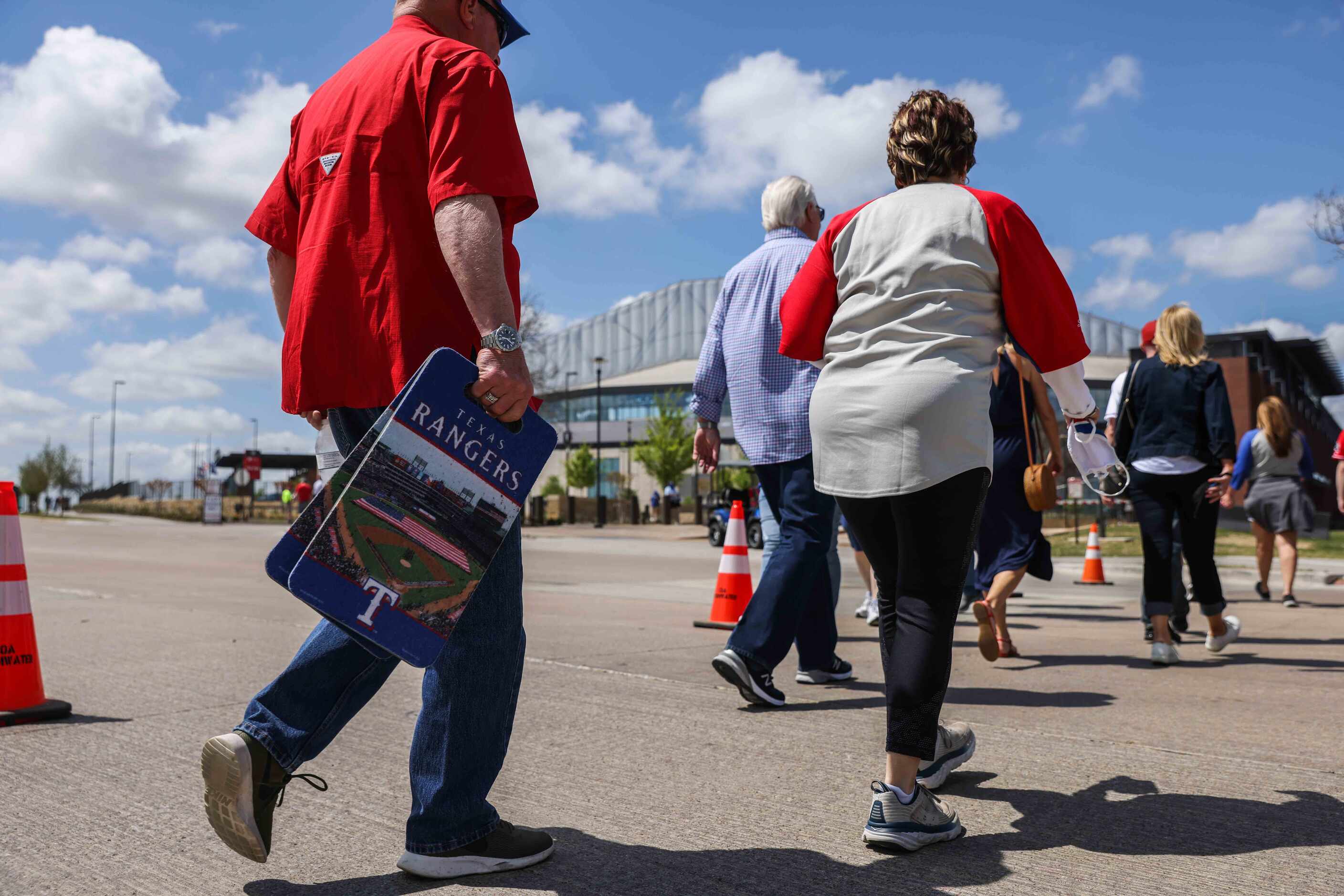 Fans walk to the Globe Life Field entrance to attend the game between Texas Rangers and...