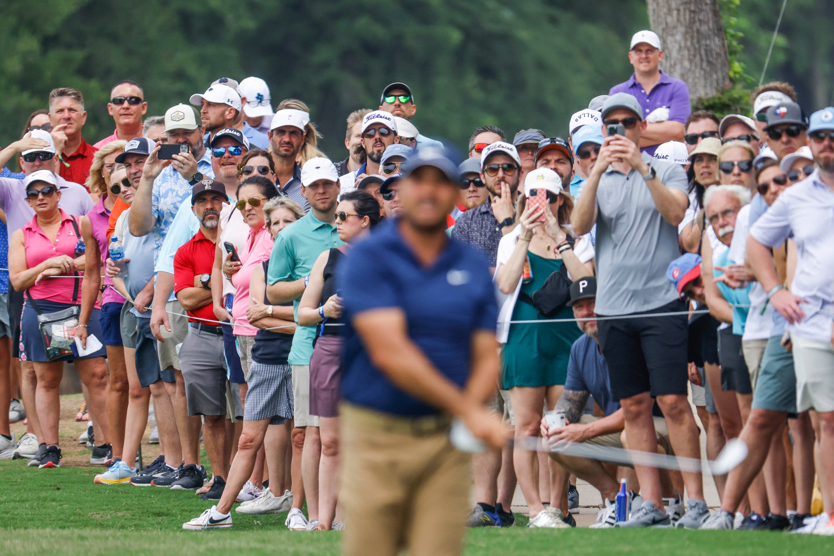 People watch as Jason Day sets to hit on the green of the ninth hole during the second round...