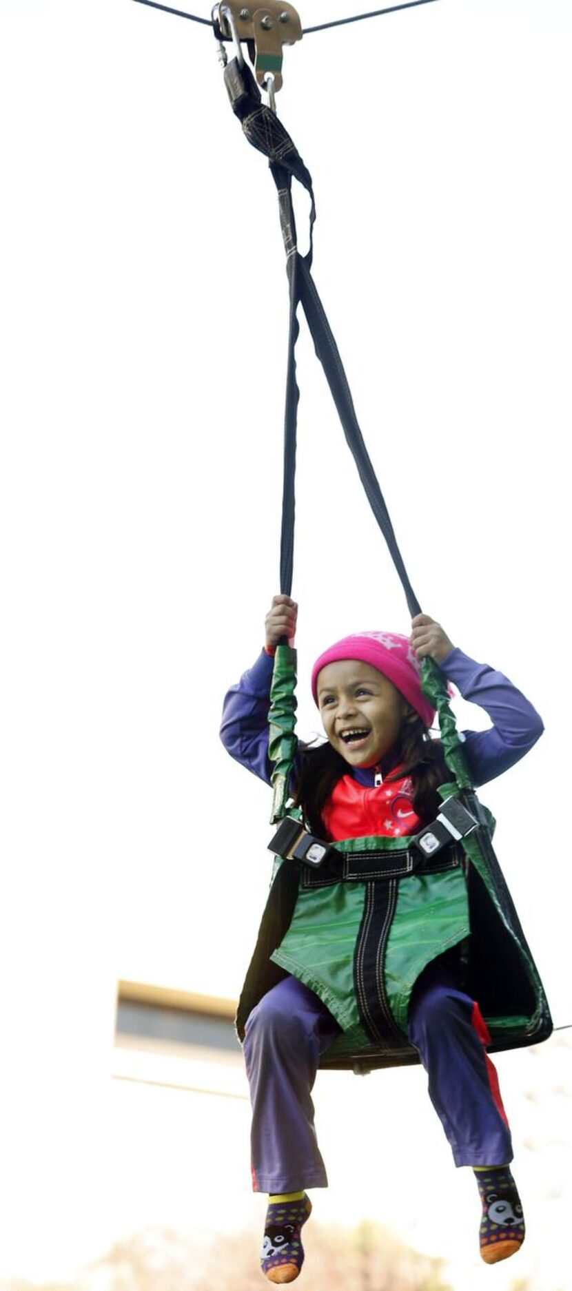 
Left: Esperanza Fuentes, 6, takes a ride on the Amazon Zip Line.
