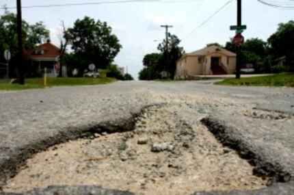  A pothole on Madison Avenue near Eighth Street in Oak Cliff in June 2010. (File Photo)