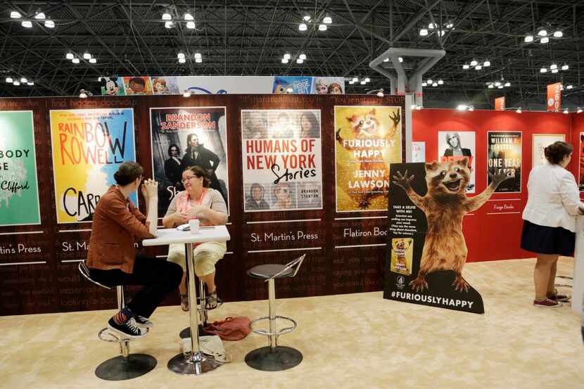 
BookExpo America attendees visit the Macmillan booth.
