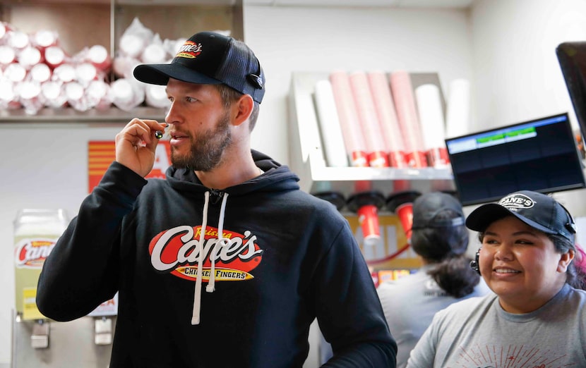 Free agent pitcher Clayton Kershaw, left,  talks on the headset as he takes drive-thru...