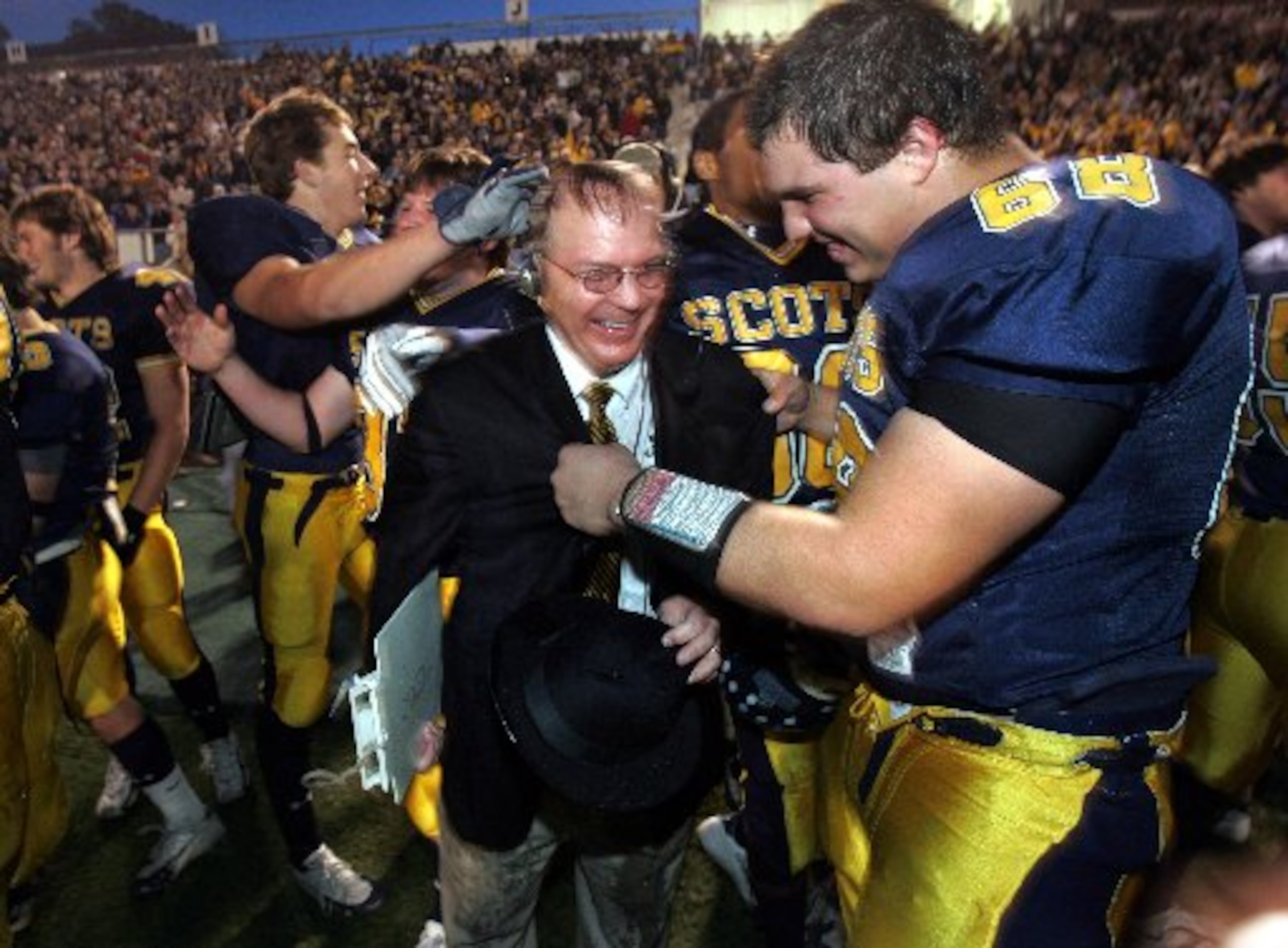 Highland Park coach Randy Allen gets consoled by Alex Cole (68 - right) after getting dunked...