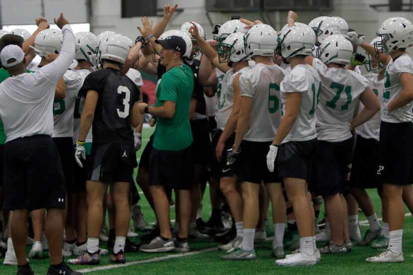 Southlake Carroll head coach Riley Dodge, center, breaks huddle after explaining a drill to...