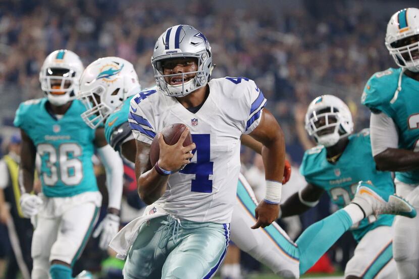 Dallas Cowboys quarterback Dak Prescott (4) scores a rushing touchdown to make the score...