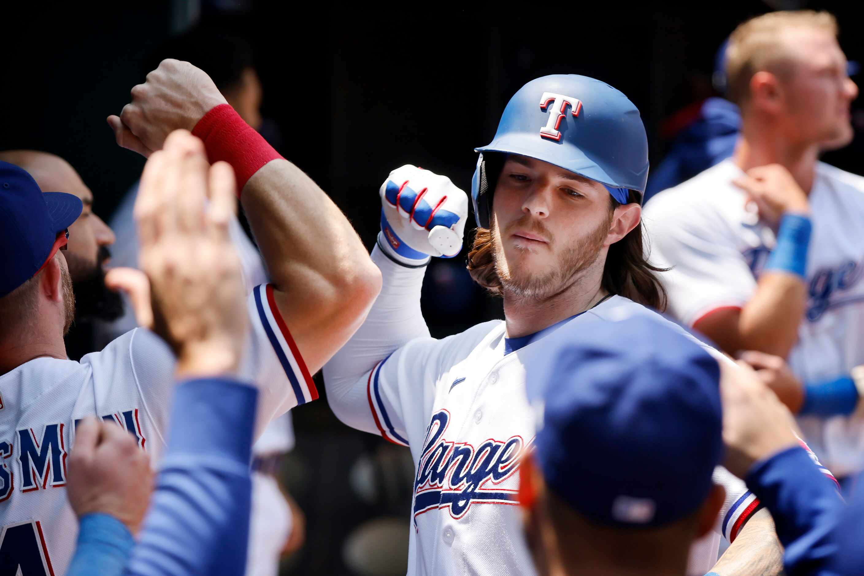 Texas Rangers designed hitter Jonah Heim (28) is congratulated by teammates after a second...