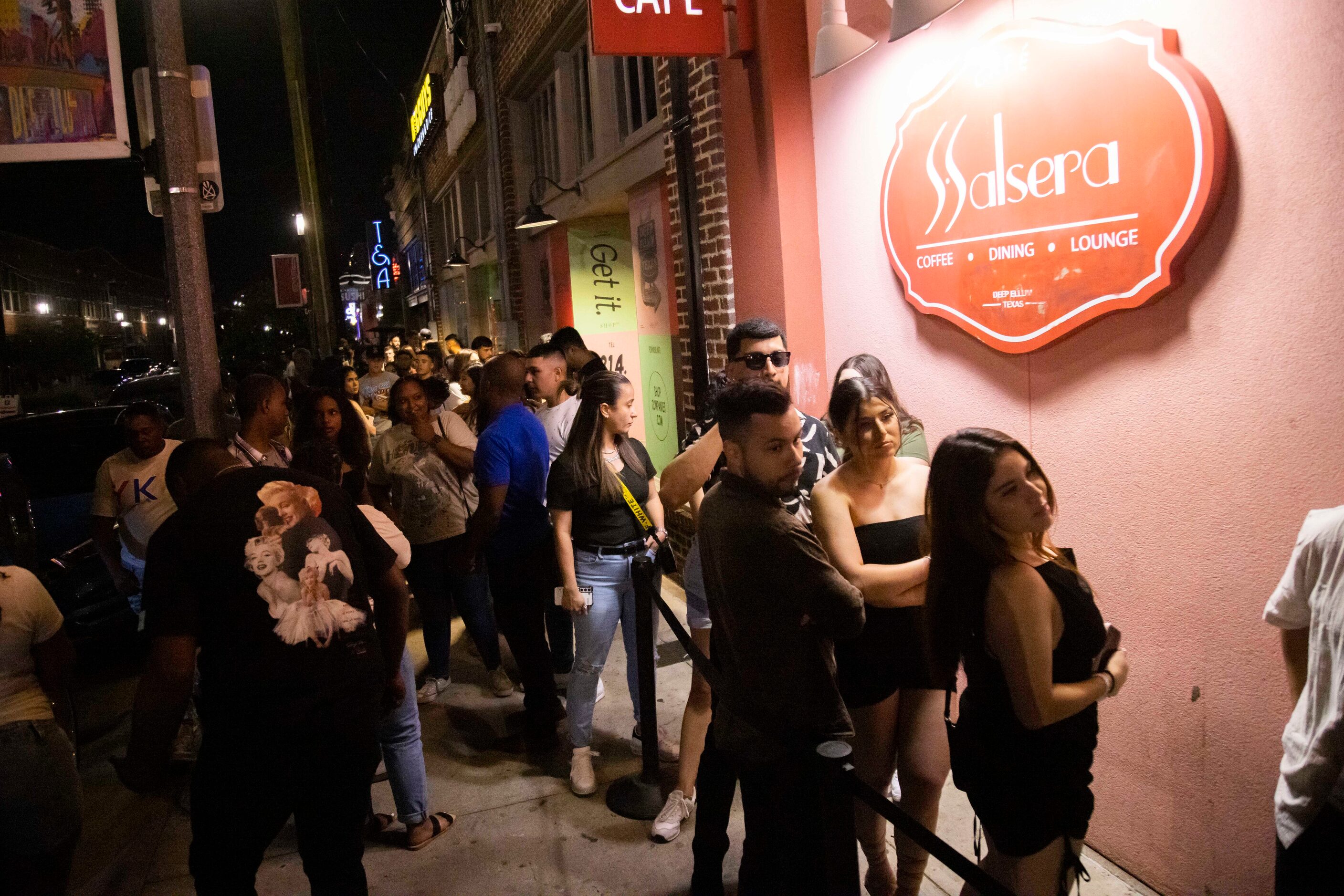 People wait in line to enter Cafe Salsera in the Deep Ellum district of Dallas on Saturday,...