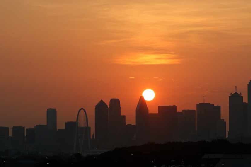 It will be another hot day in Dallas as the sun rises over the skyline on Friday, July 31,...