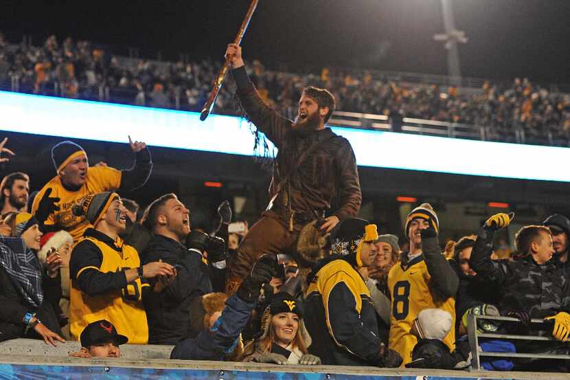 MORGANTOWN, WV - DECEMBER 03: The West Virginia Mountaineer mascot interacts with fans in...