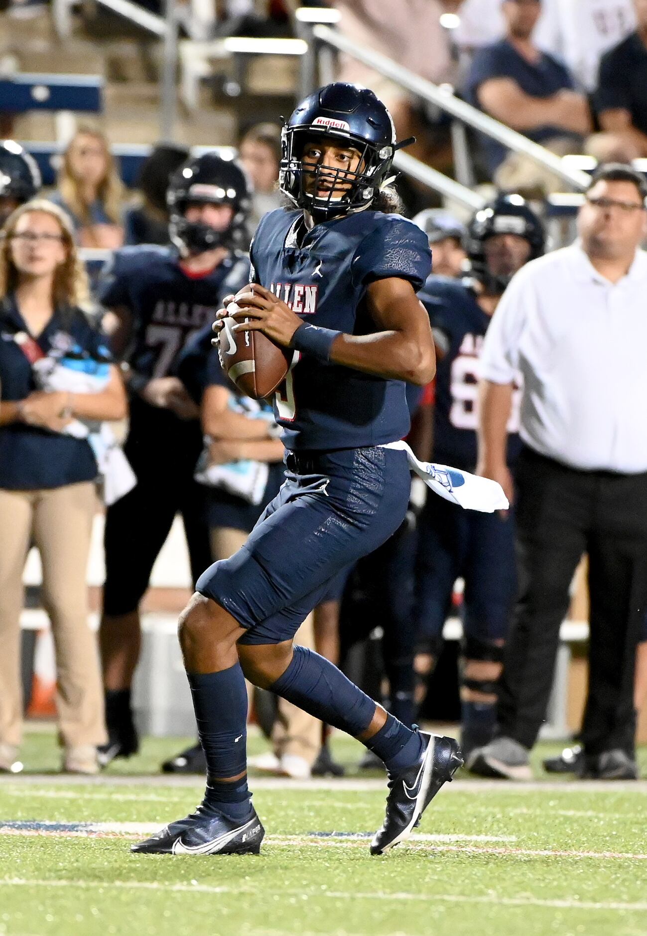 Allen's Mike Hawkins (3) looks to pass in the first half of a high school football game...