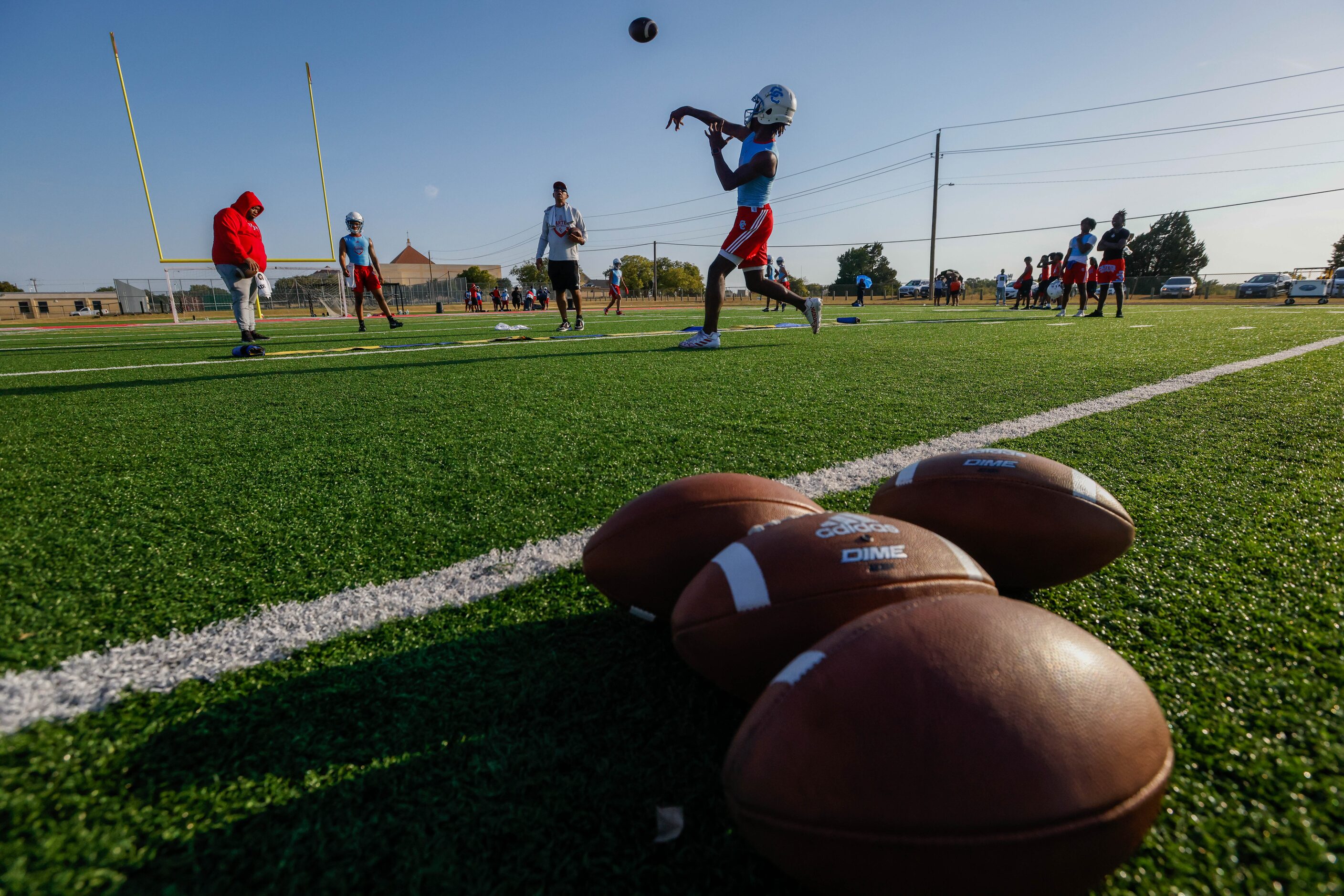 Quarterback Caleb Richardson releases a pass during a drill at the first practice of the...