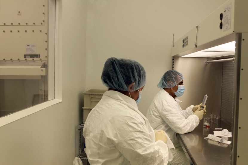  Pharmacy technicians work in a sterile compounding lab in North Dallas in October 2012....