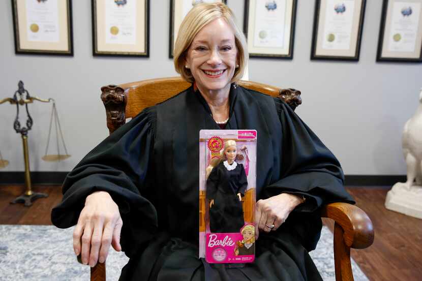 Fifth District Court of Appeals Justice Lana Myers sits in her office holding a Judge Barbie...
