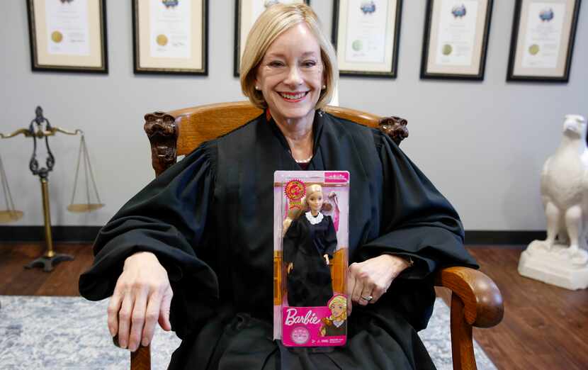 Fifth District Court of Appeals Justice Lana Myers sits in her office holding a Judge Barbie...