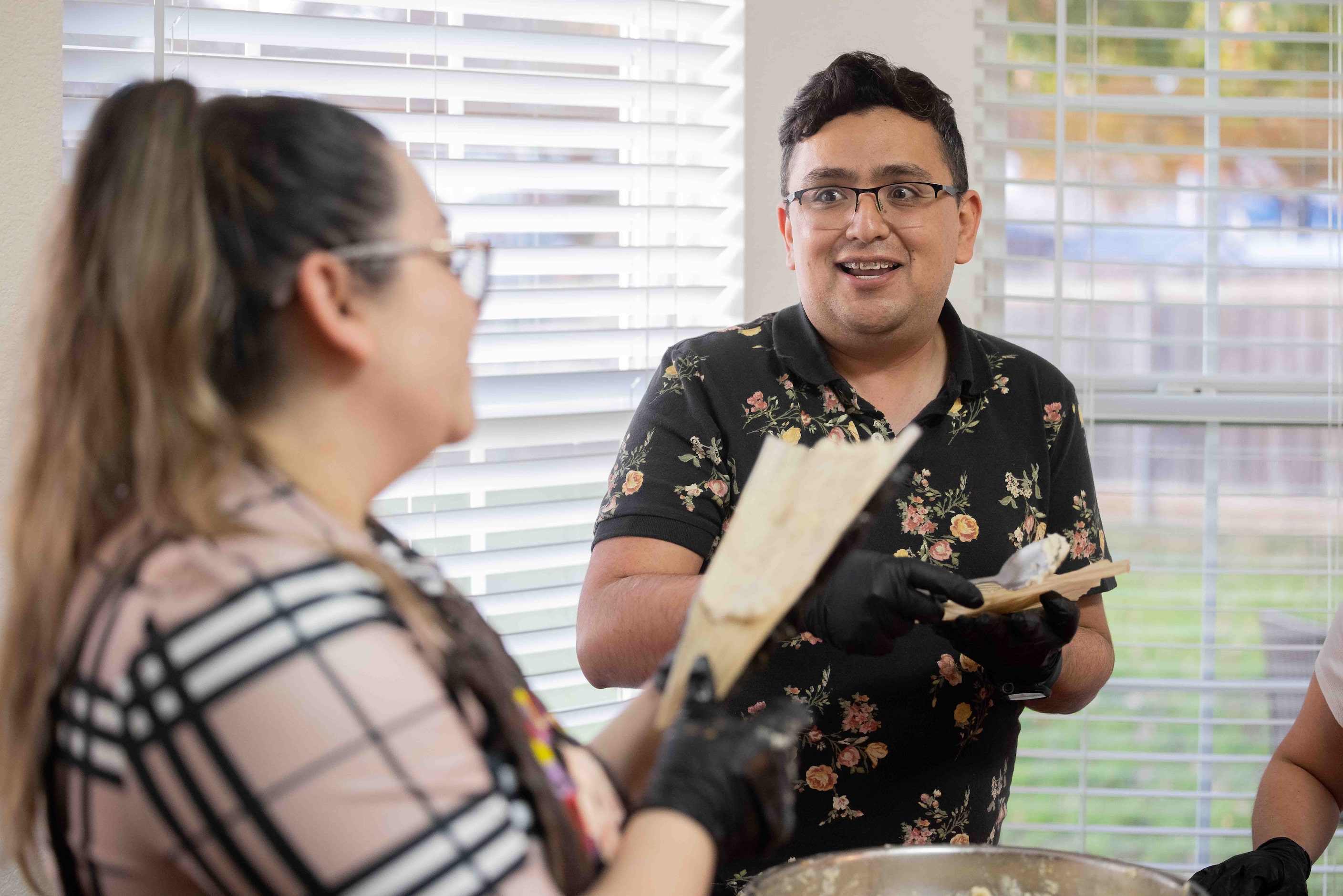 Luis Infante (right) of San Luis Potosí chats with Sara Klein, the hostess behind the...