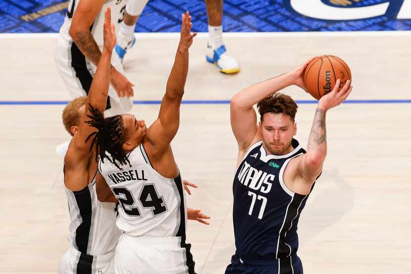 San Antonio Spurs guard Devin Vassell (24) defends as Dallas Mavericks guard Luka Doncic...