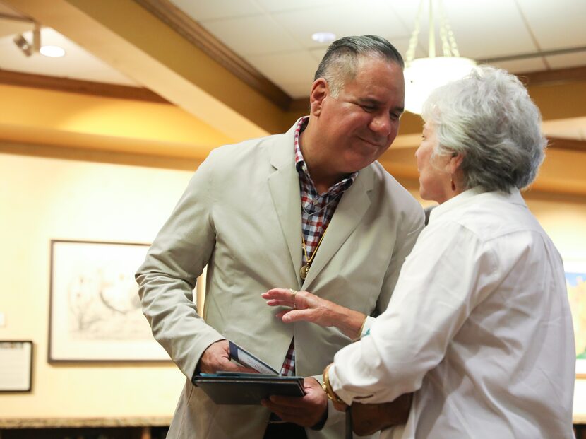 Jacques DeLira (left) turns to his mother Jo DeLira after reading a card from her after his...