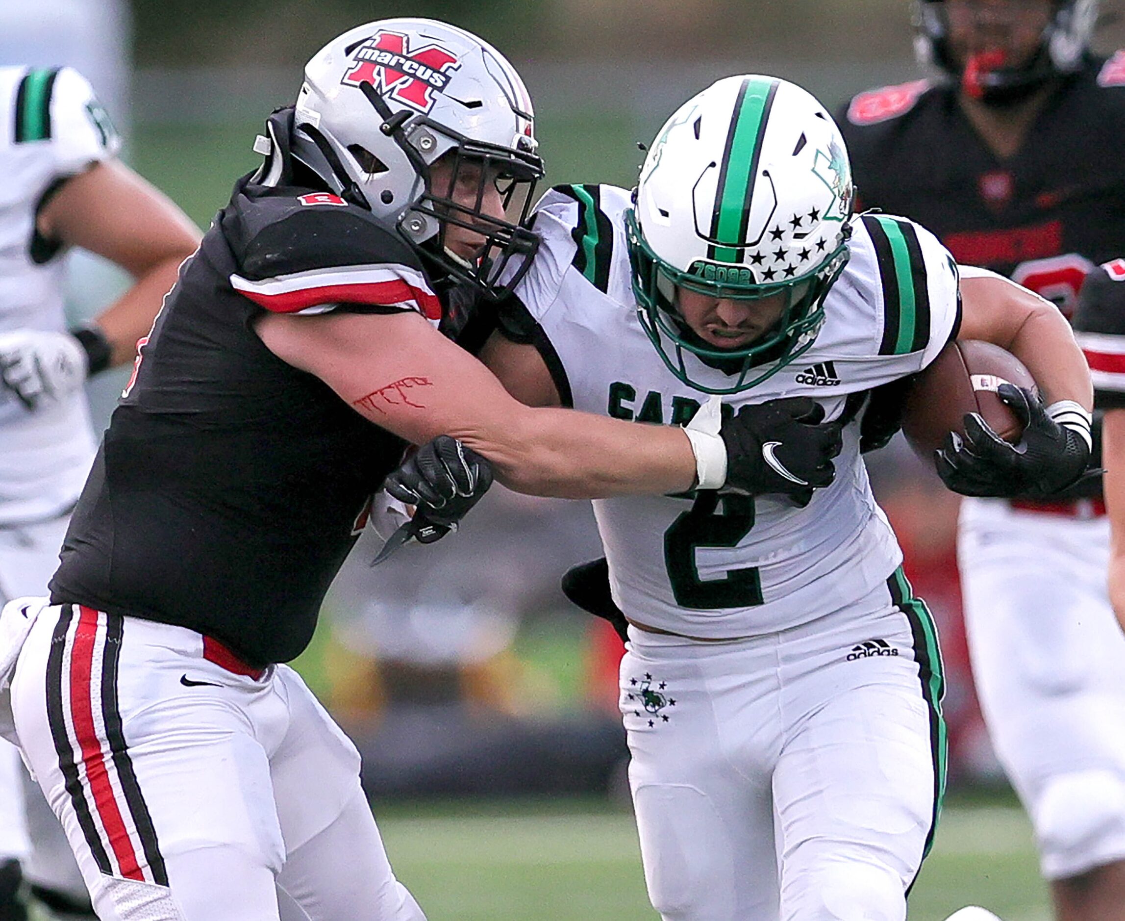 Southlake Carroll running back Owen Allen (2) fights for yardage against Flower Mound Marcus...