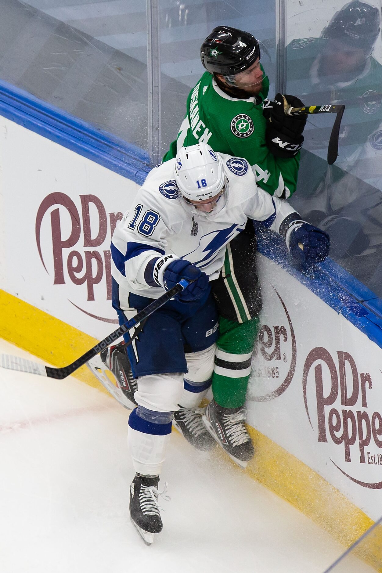 Miro Heiskanen (4) of the Dallas Stars battles against Ondrej Palat (18) of the Tampa Bay...