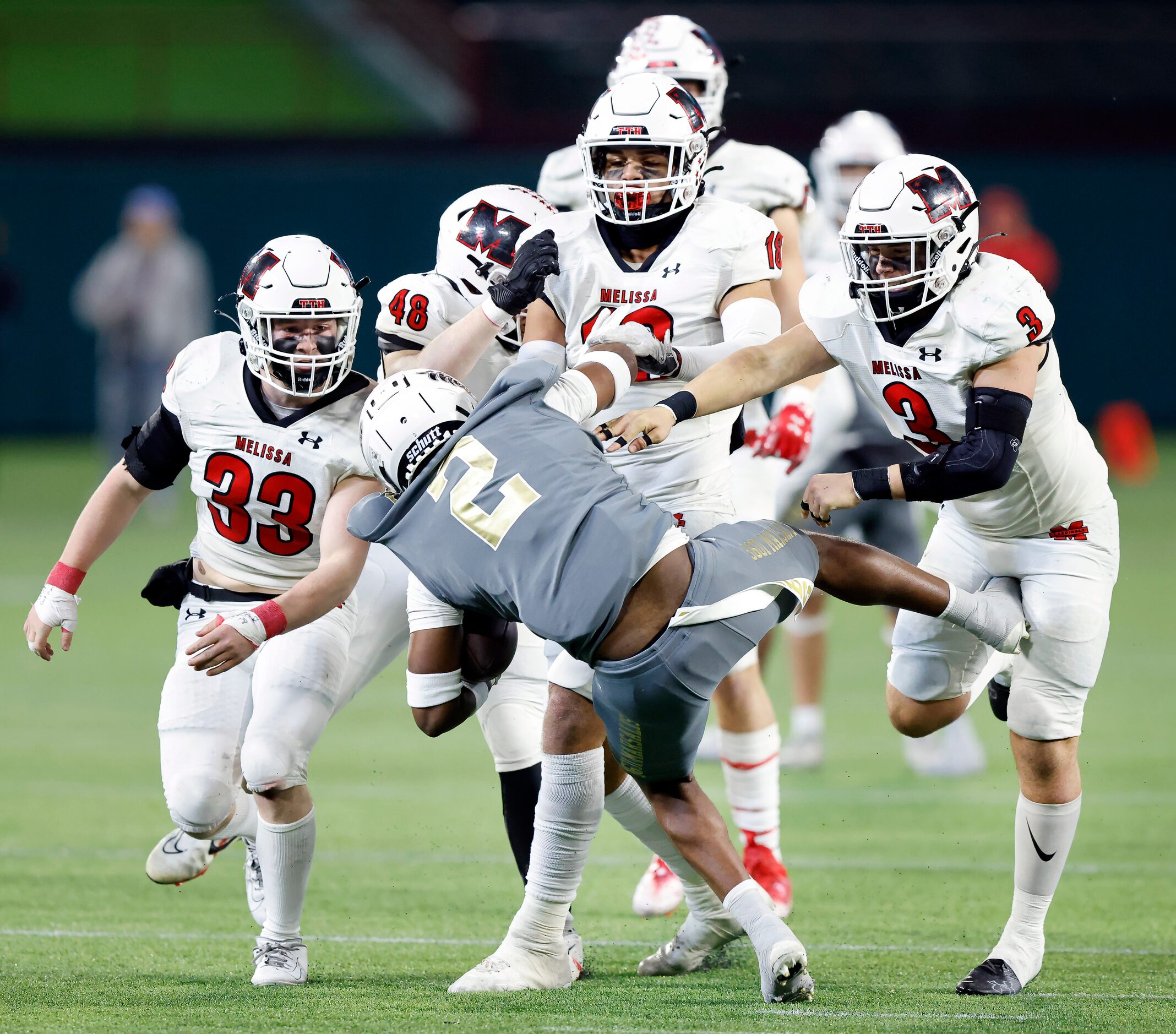 South Oak Cliff running back Tedrick Williams (2) is picked up and thrown to the ground as...