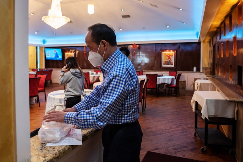 General Manager Michael Chan prepares a to-go order from Kirin Court restaurant in...