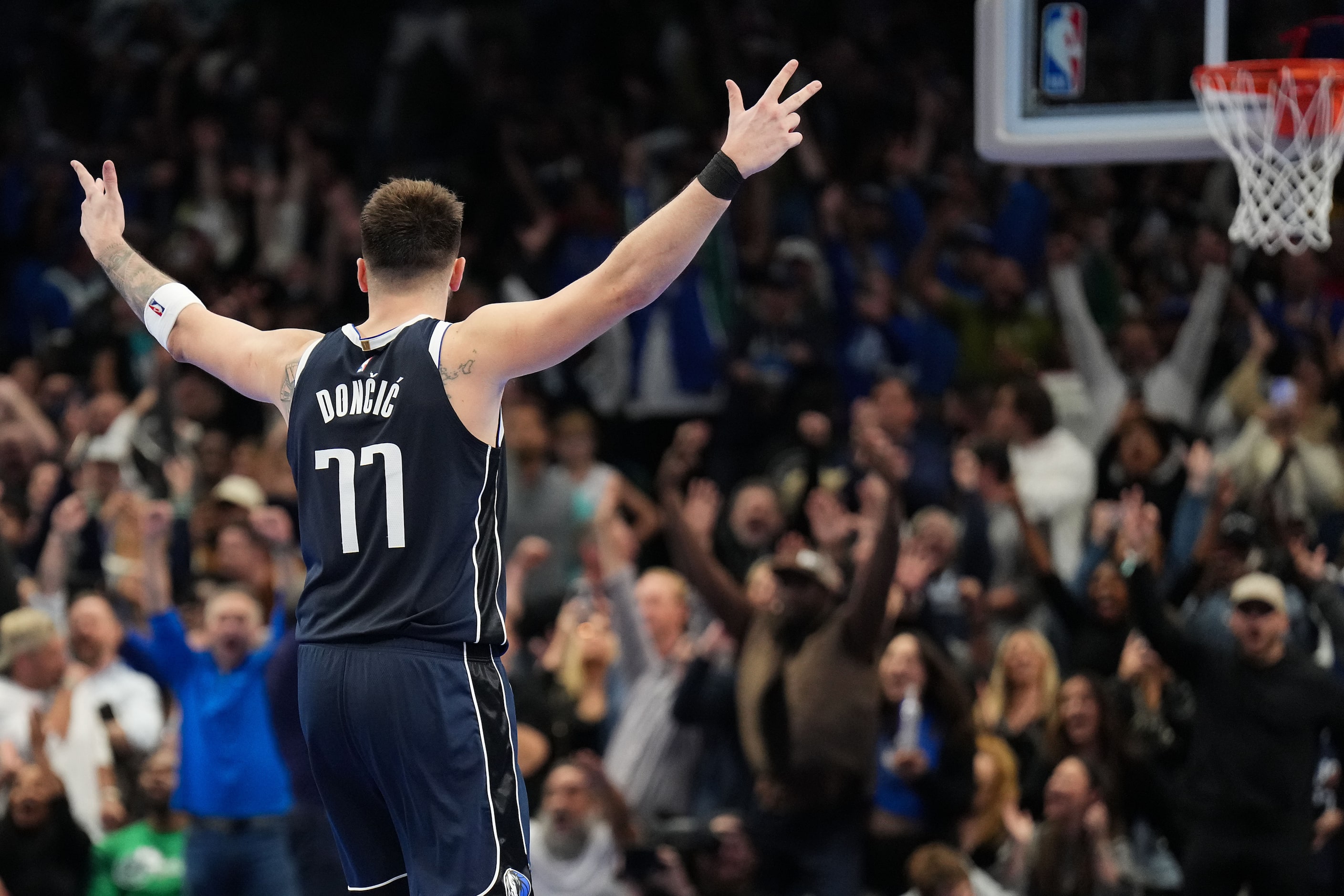 Dallas Mavericks guard Luka Doncic celebrates a late 3-pointer by guard Spencer Dinwiddie...