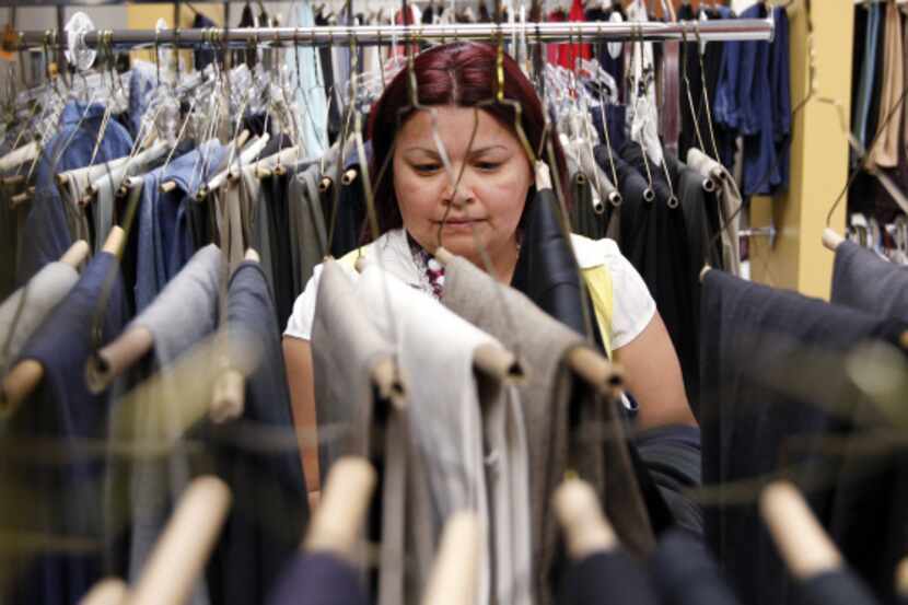 Janice Compos of Garland looks for clothes for her family at Network of Community Ministries...
