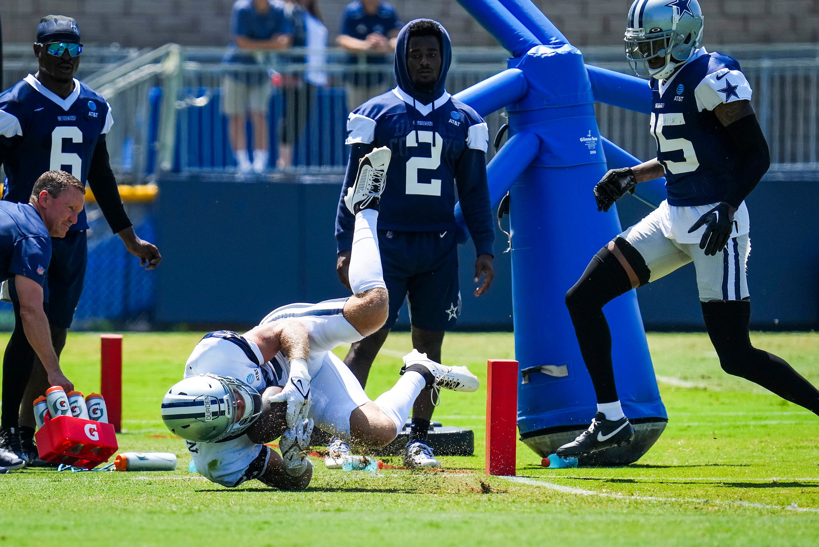 Dallas Cowboys wide receiver David Durden (85) tumbles after making a diving catch as...