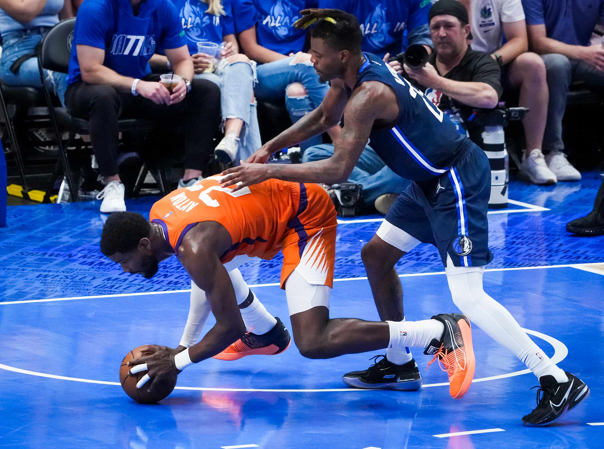 Phoenix Suns center Deandre Ayton (22) is fouled by Dallas Mavericks forward Reggie Bullock...