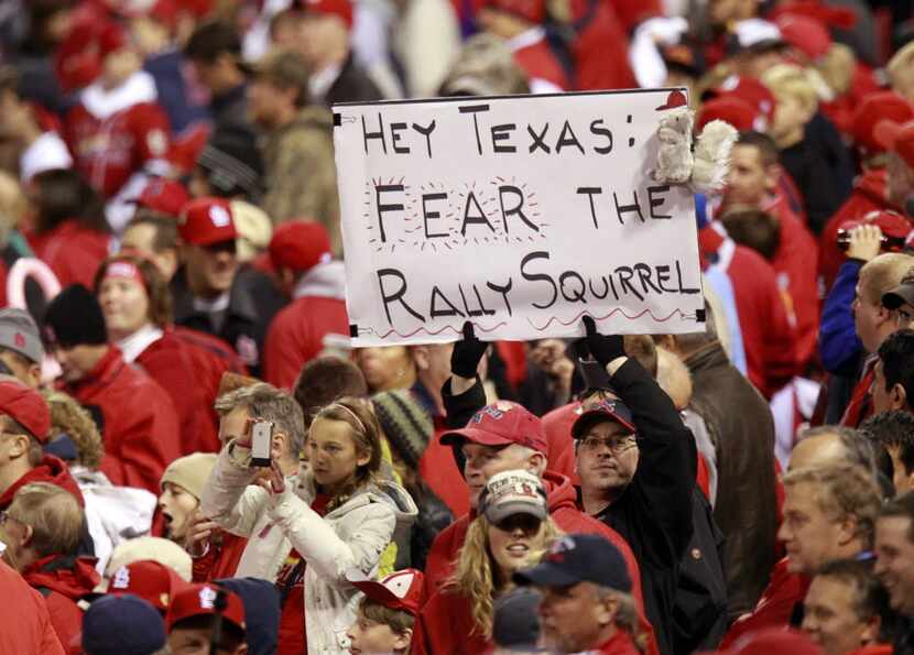 A fan holds up a Rally Squirrel sign during Game 2 of the World Series between the Texas...