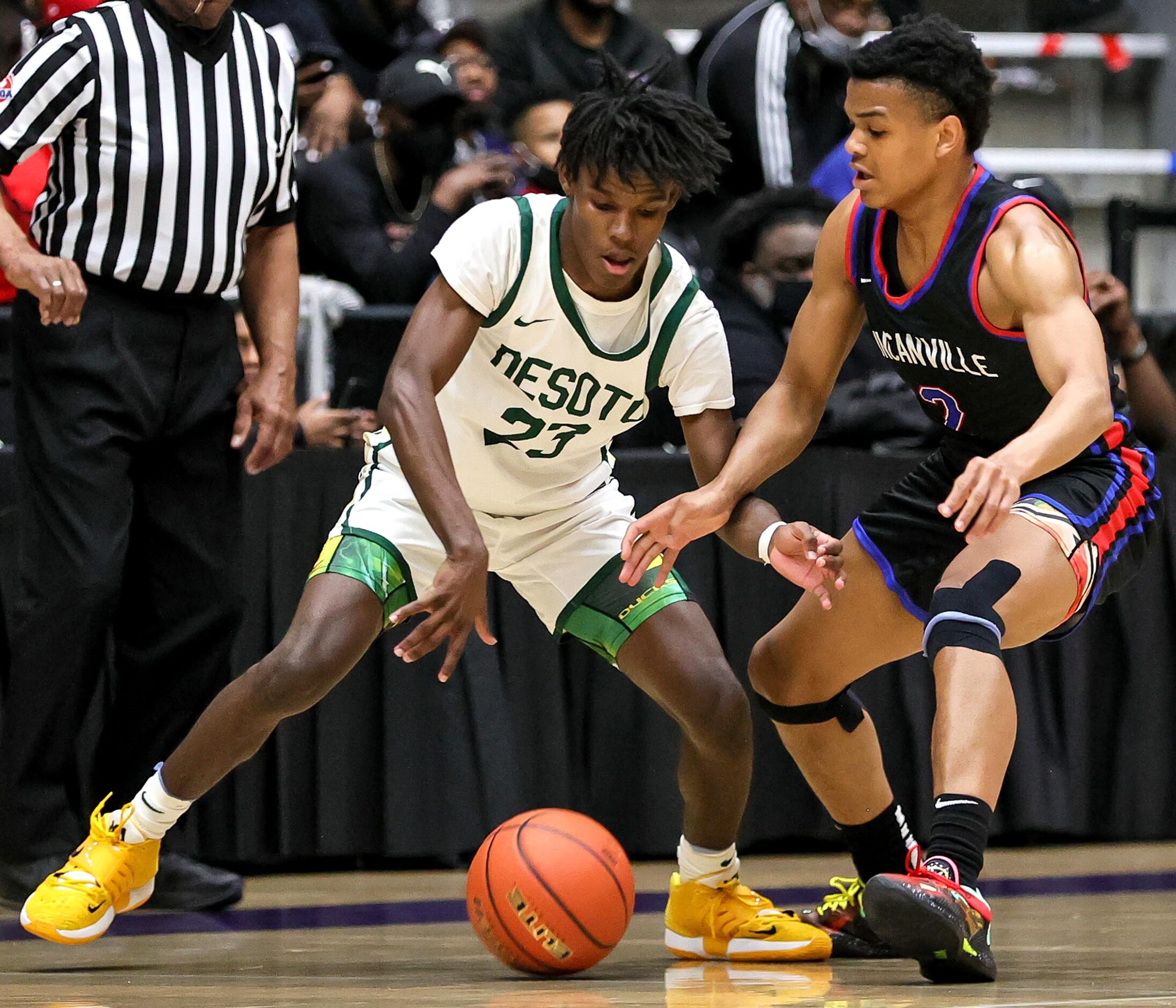 DeSoto guard Malik Jones (23) and Duncanville guard Evan Phelps (2) go for a loose ball...