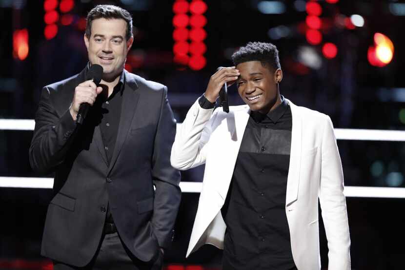 Host Carson Daly stands by Malik Heard during Season 10 of "The Voice." The winner will be...