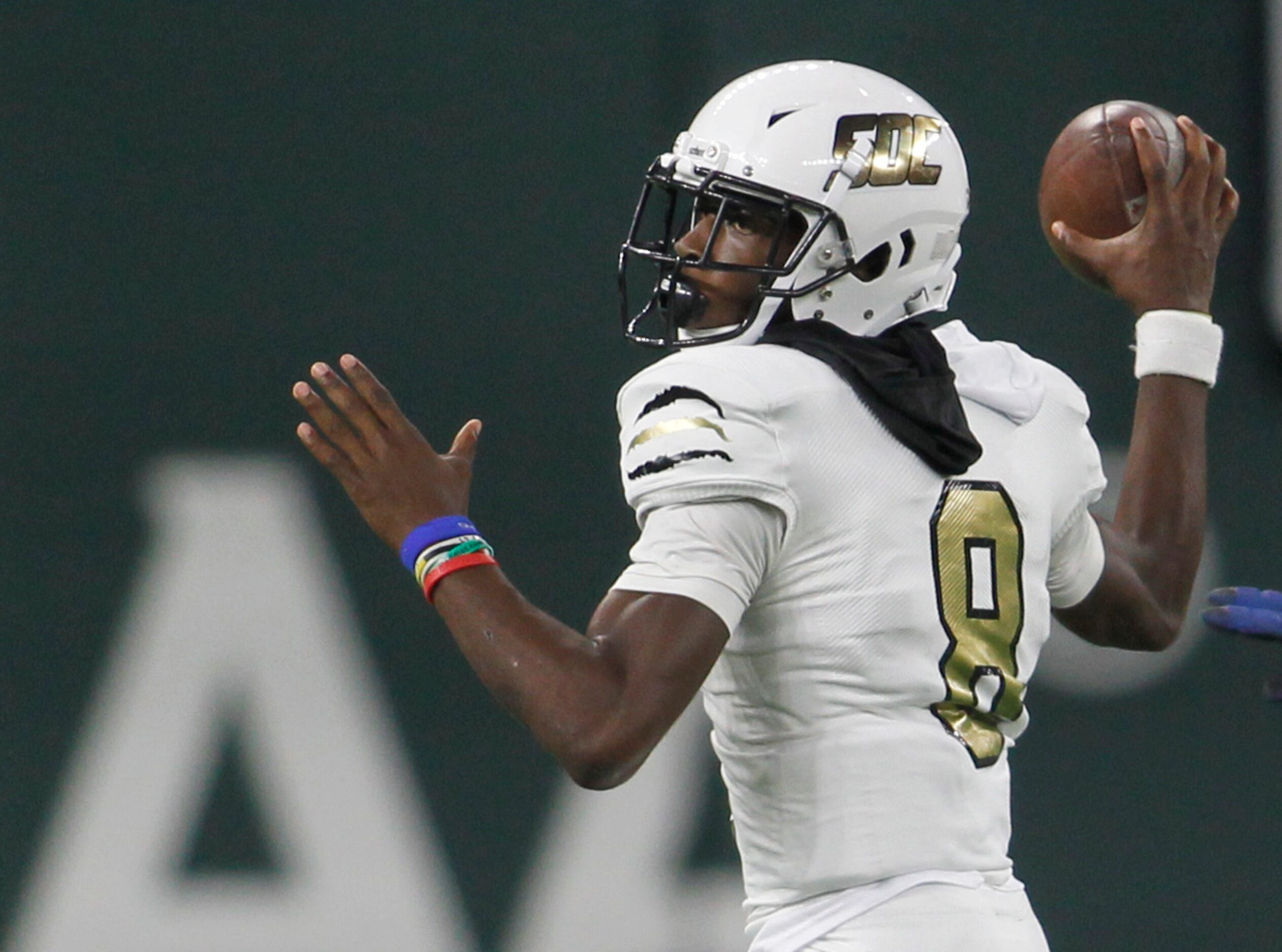 South Oak Cliff quarterback Kevin Henry-Jennings (8) prepares to launch a pass downfield...