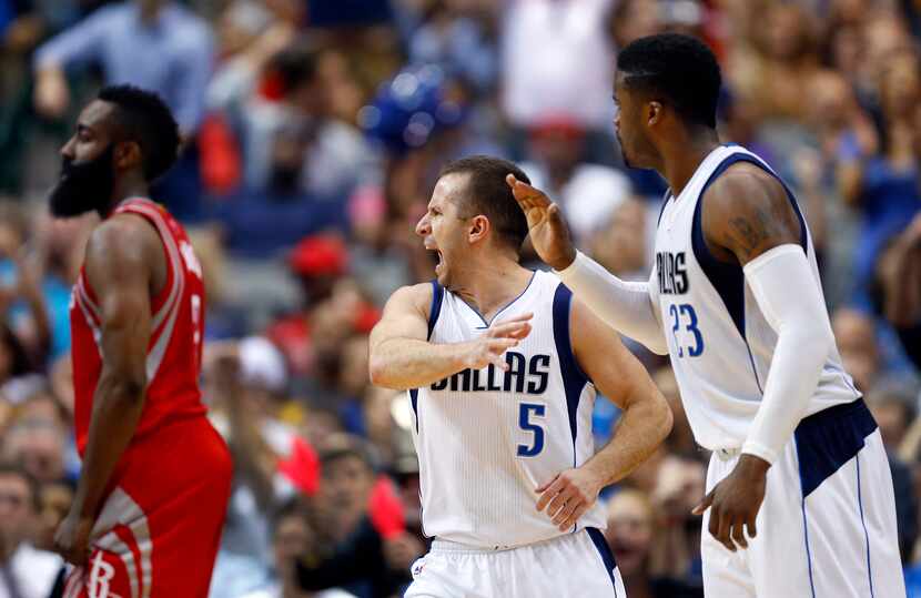 Dallas Mavericks guard J.J. Barea (5) is congtaulted by Wesley Matthews (23) after hitting a...