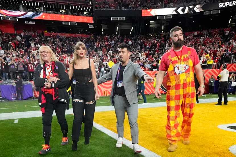 Donna Kelce, left, Taylor Swift, center, and Jason Kelce, right, celebrate after the NFL...