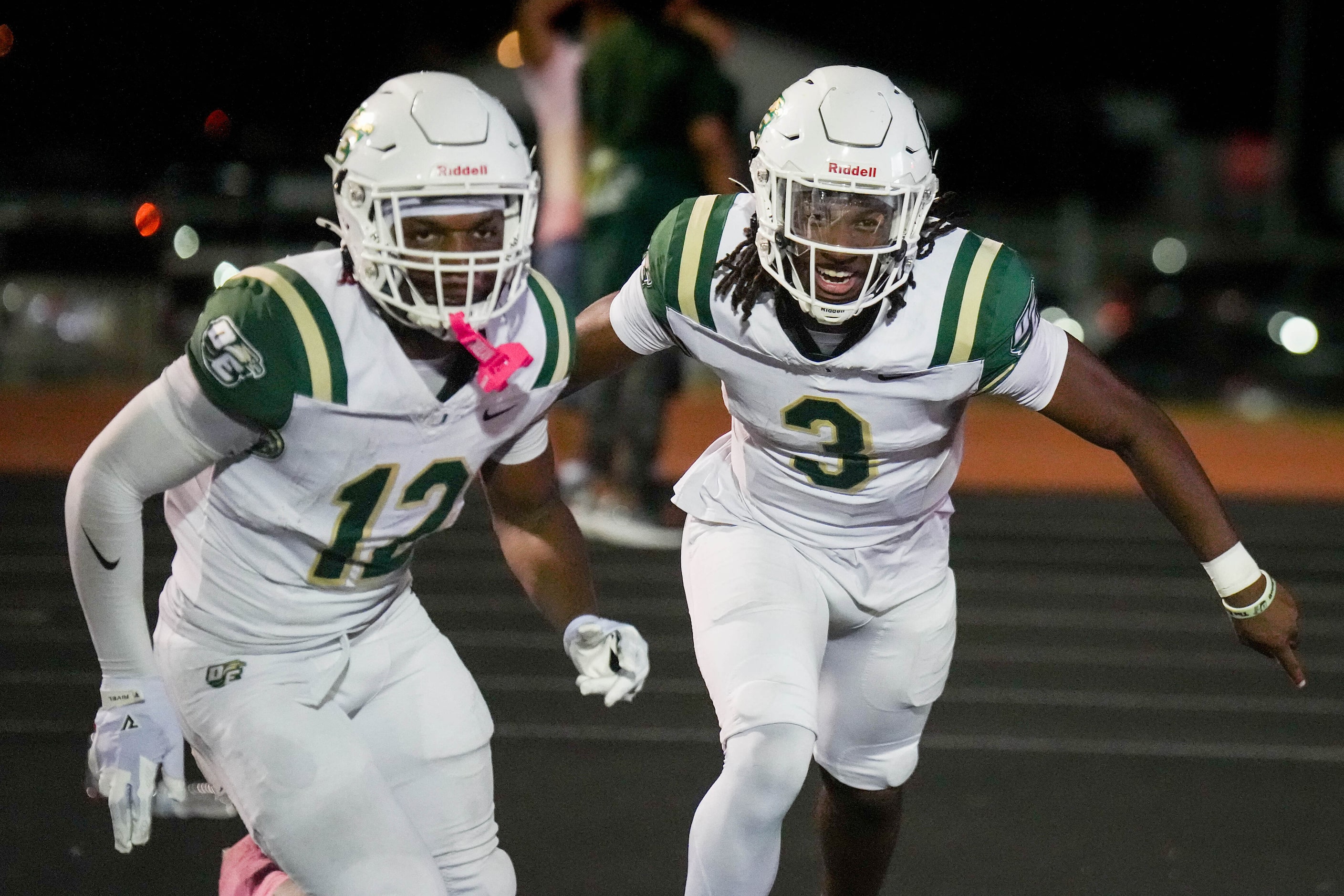 DeSoto quarterback Kelden Ryan (3) celebrates with running back SaRod Baker (12) after...