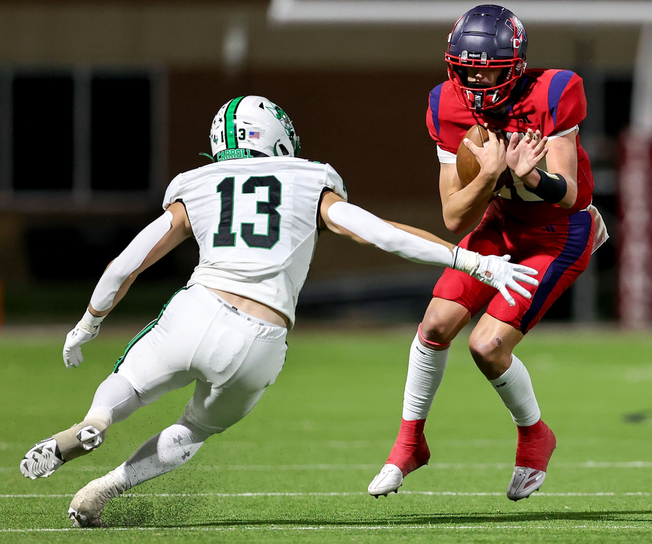 Justin Northwest quarterback Trey Poe (R) avoids getting sacked by Southlake Carroll...