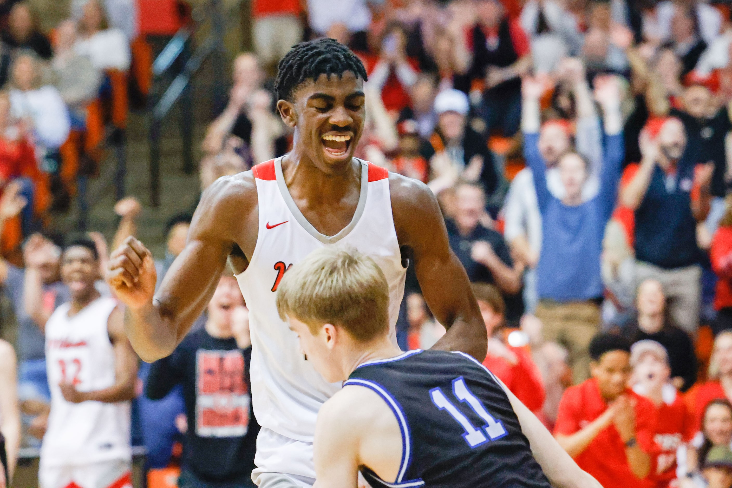 Lake Highlands High School' Samson Aletan celebrates a dunk against Byron Nelson High School...