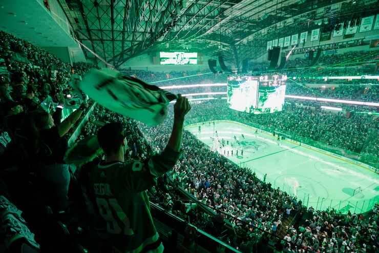 Fans stand and cheer as the Dallas Stars take the ice before Game 5 of an NHL hockey Stanley...