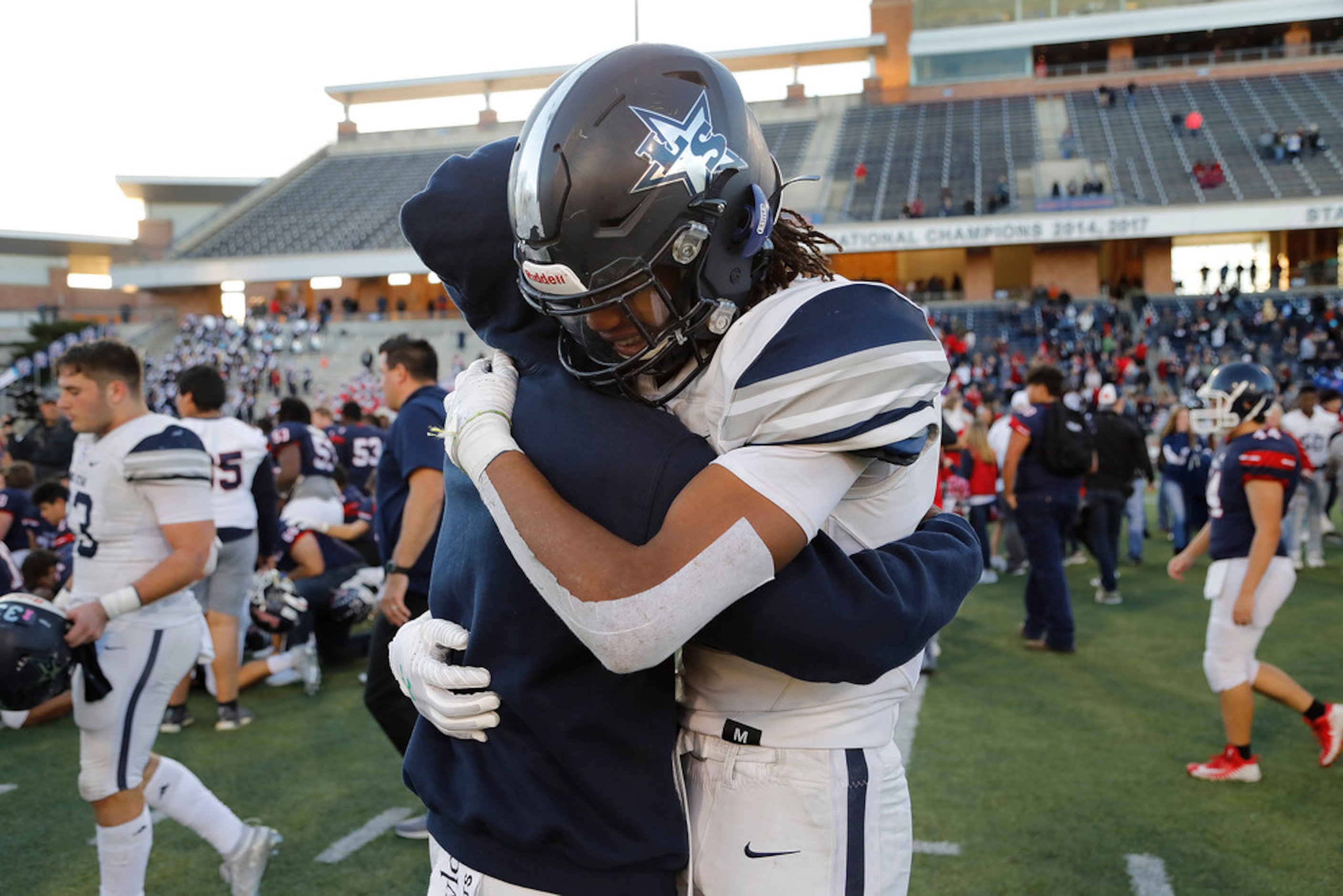 Lone Star High School outside linebacker Toren Pittman (15) embraces Lone Star High School...