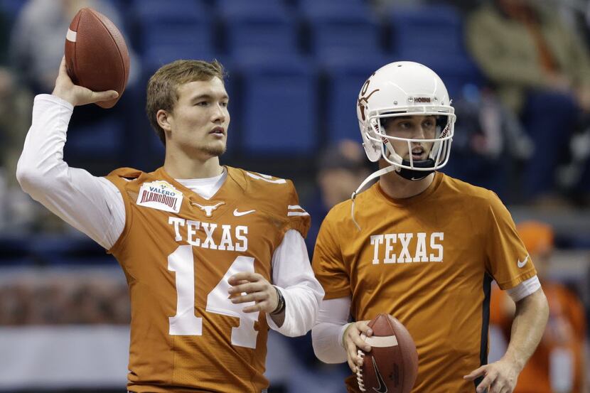 Texas quarterbacks David Ash, left, and Case McCoy, right, throw before the Valero Alamo...