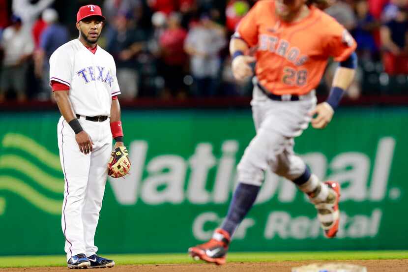 Texas Rangers shortstop Elvis Andrus (left) watches Houston Astros Colby Rasmus round second...