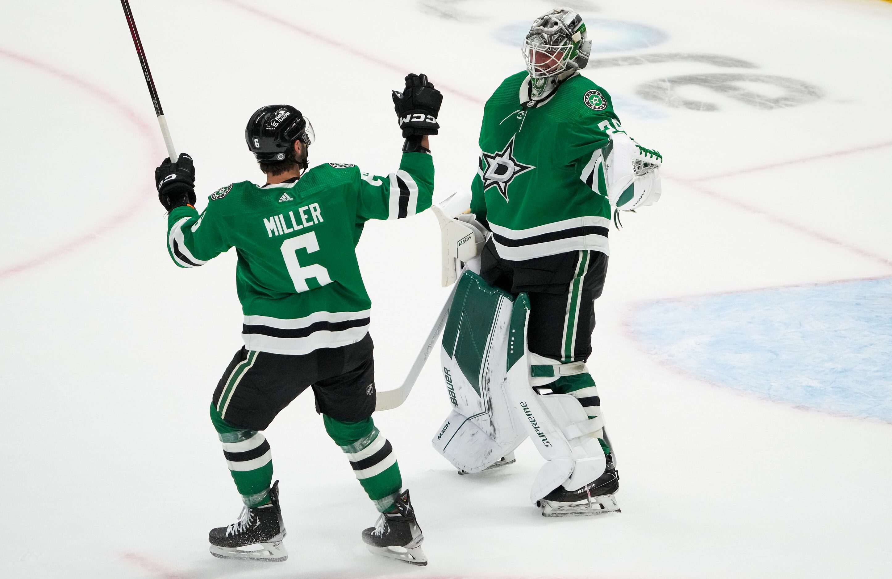 Dallas Stars goaltender Jake Oettinger (29) celebrates with defenseman Colin Miller (6)...