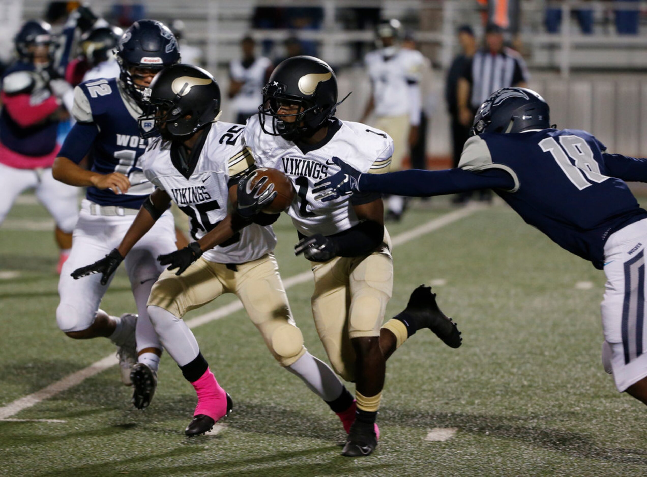 Pinkston's Bronya Todd (1) runs behind the block of Michael Sloan (25) as Ranchview's Flavio...