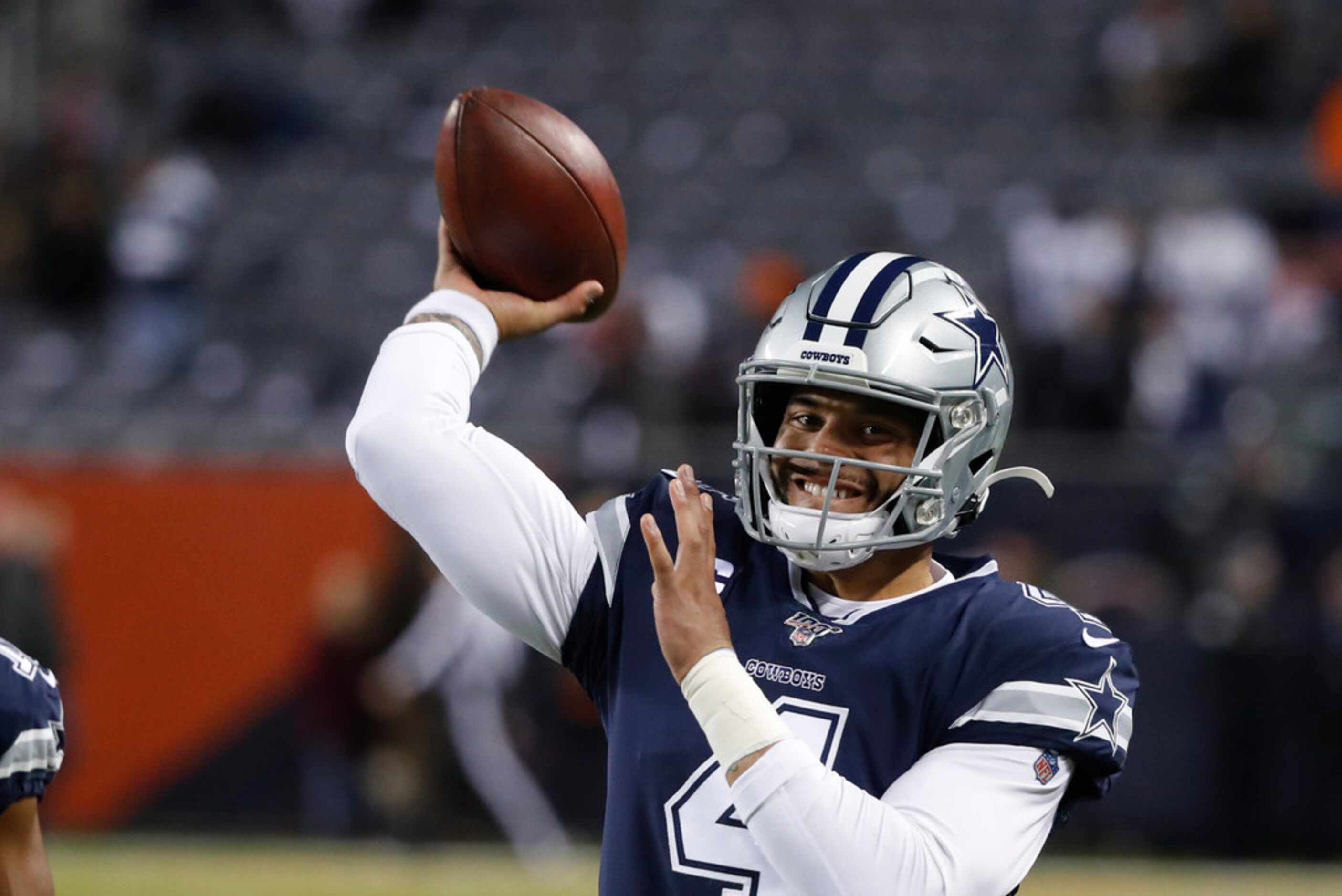 Dallas Cowboys quarterback Dak Prescott warms up for the team's NFL football game against...