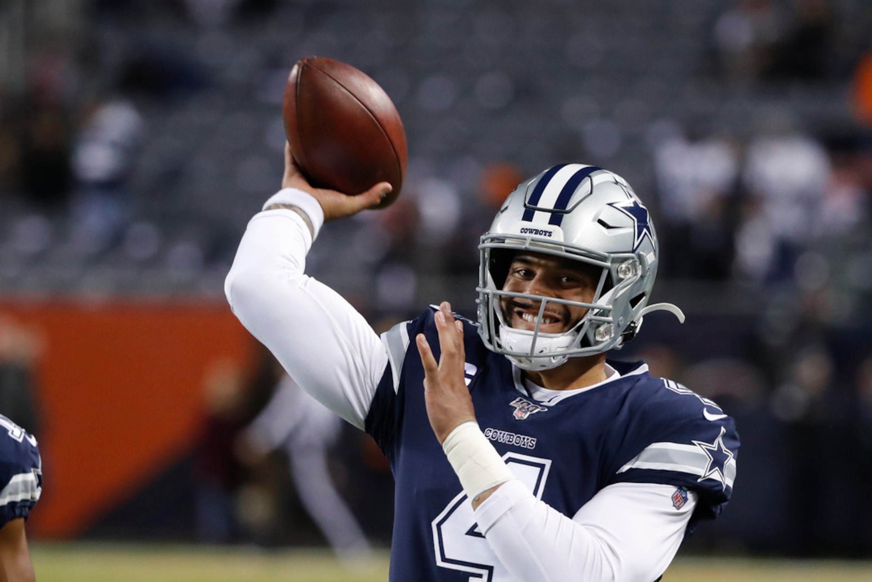 Dallas Cowboys quarterback Dak Prescott warms up for the team's NFL football game against...