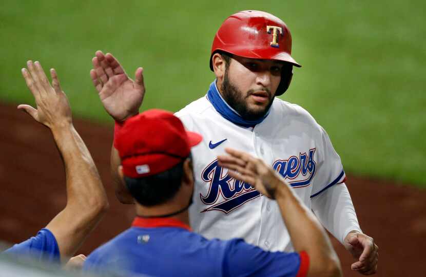 Texas Rangers Jose Trevino (56) is congratulated on his run during the second inning against...