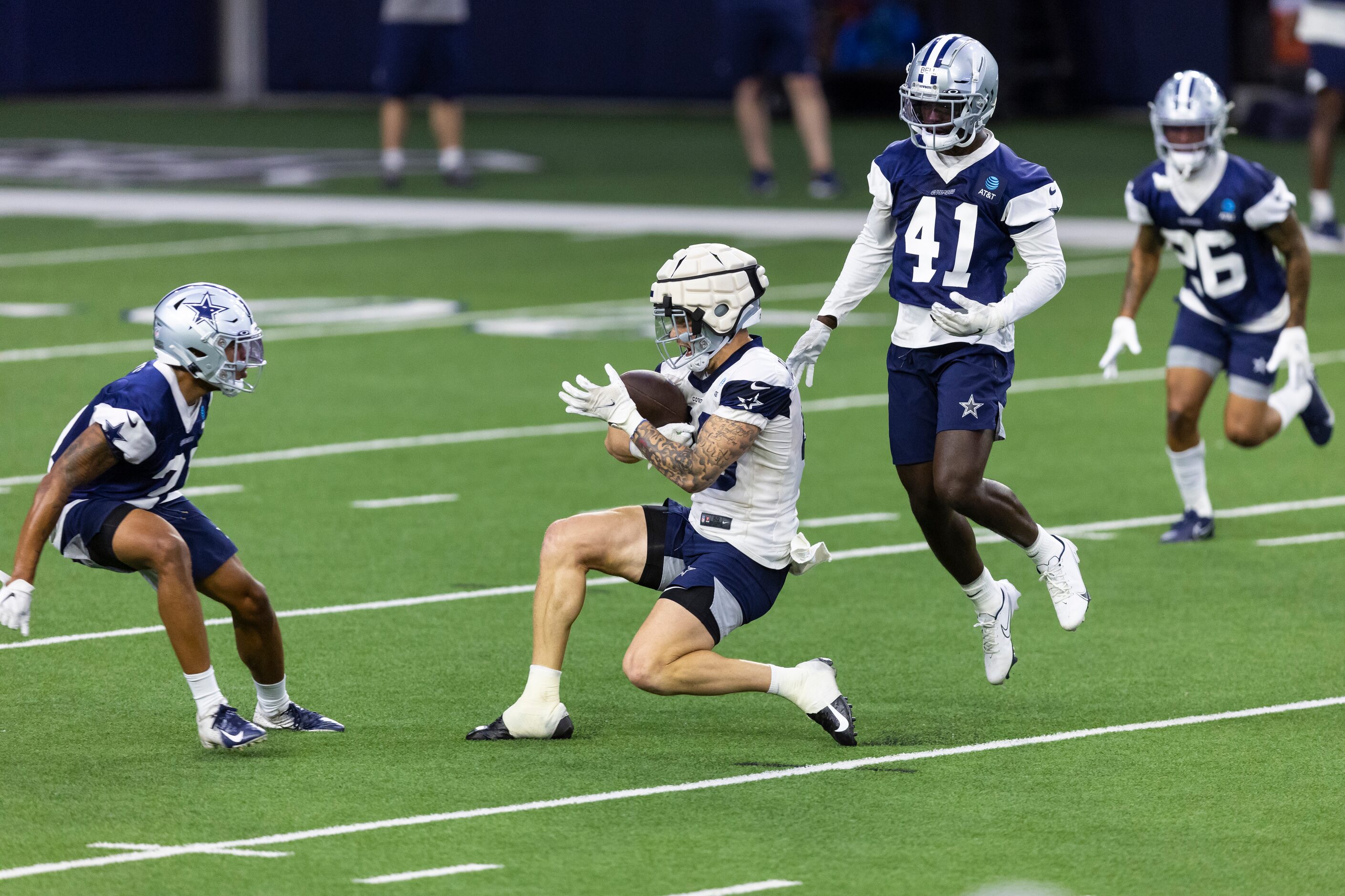 Dallas Cowboys tight end Peyton Hendershot, center, catches a pass as safety Tyler Coyle,...