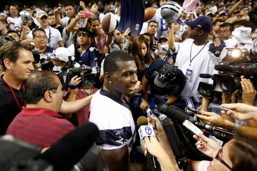 Dallas Cowboys Dez Bryant (88) answers questions from the media as he signs autographs after...