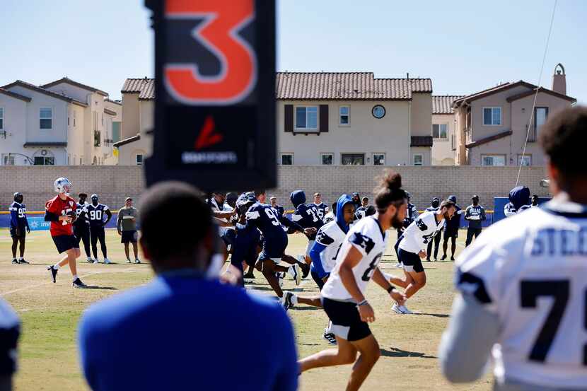 Dallas Cowboys quarterback Cooper Rush (10) drops back to pass during a training camp...